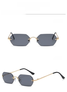 Detalle de gafas de sol de metal dorado con lentes oscuras y almohadillas nasales