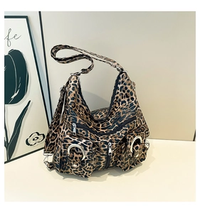 Detailed view of leopard print tote bag with multiple pockets and silver metal rings