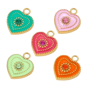 Macro detail of colorful heart enamel pendants with gold borders and central rhinestones
