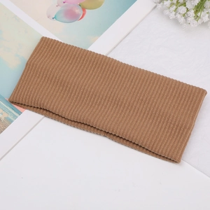 Macro detail of caramel brown ribbed knit headband fabric with soft vertical texture