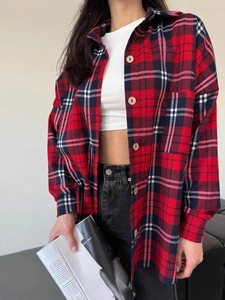 Classic red plaid flannel shirt with oversized fit and long sleeves on female model