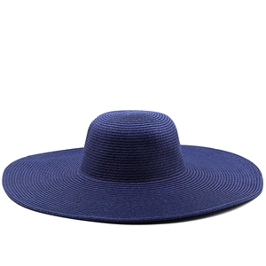 Detailed view of spiral woven texture on a 13cm wide brim navy blue straw sun hat