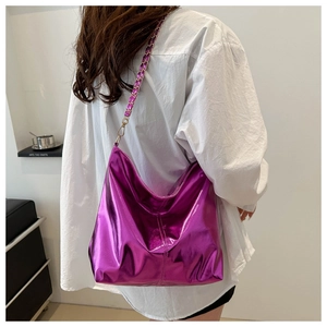 Detail of purple metallic tote bag with gold chain and woven leather shoulder strap