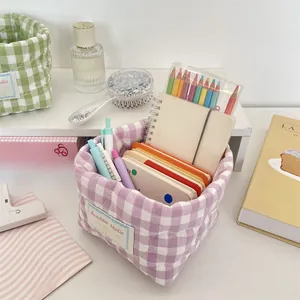 Detailed shot of a purple quilted gingham fabric storage basket with office stationery