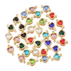 Macro shot of colorful heart crystal pendants with gold metal base and double loops