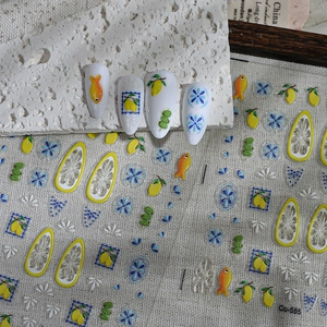 Detailed view of lemon and floral nail stickers Co-555 on white artificial nails