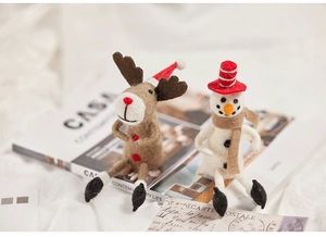 Handmade wool felt reindeer and snowman dolls as festive tabletop Christmas decorations