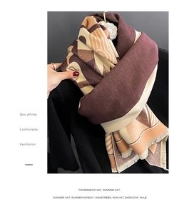 Detail of soft faux cashmere scarf with geometric poker pattern and fringe trim