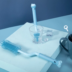 Close-up of blue silicone baby bottle brushes and nipple cleaner with bear-shaped handles