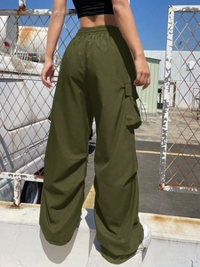 Detail view of military green cargo pants with multi-pockets and elastic high waist design