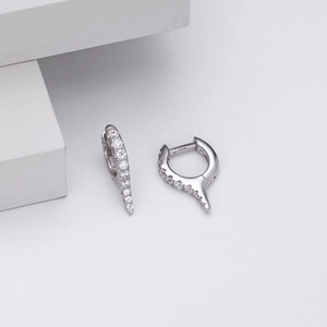 Detailed macro view of S925 sterling silver huggie earrings with sparkling zircons