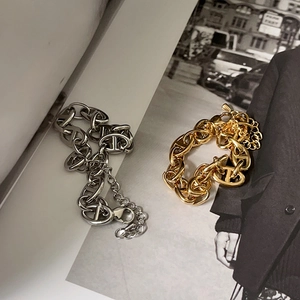 Detail of 18k gold and silver chunky pig nose chain bracelets with T-bar and lobster clasps