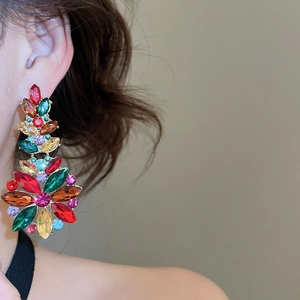 Close-up of colorful crystal flower earrings with multi-layered gemstone dangles