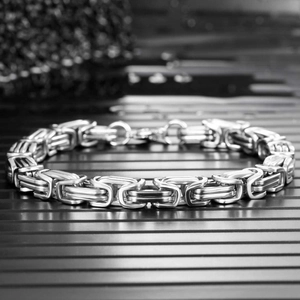 Detail of silver Byzantine chain necklace in stainless steel with complex woven texture