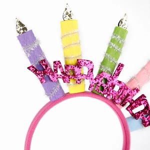 Pink Happy Birthday headband with colorful felt candles and glitter lettering for party decor