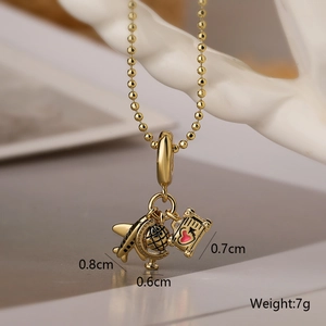 Detail view of gold airplane, globe, and passport charms with size and 7g weight specs