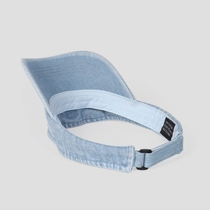 Detail view of denim sun visor showing 100% cotton fabric and adjustable strap closure