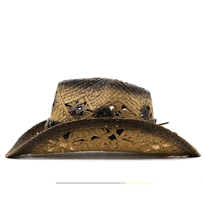 Detail of hand-woven straw cowboy hat featuring floral cutouts and studded leather band
