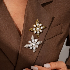 Baroque cross brooch with imitation pearls and rhinestones on deep brown blazer lapel