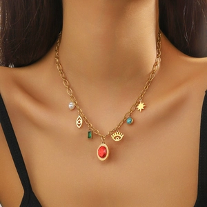 Vintage gold O-chain necklace with pearl, star, evil eye, and multi-color gemstone charms