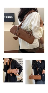 Detail of retro caramel brown shoulder bag featuring bow knot and heart charm