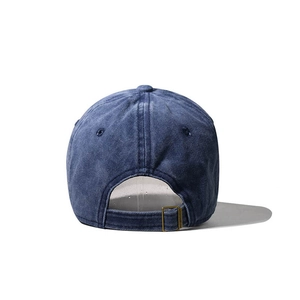 Rear view of washed denim baseball cap with adjustable bronze metal buckle strap