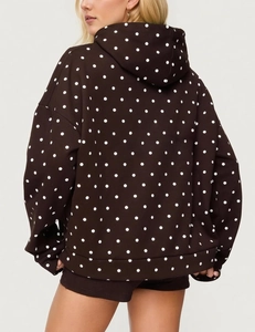 Back view of a loose fit dark brown hoodie with white polka dot print for women