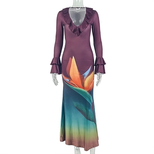 Detail of V-neck ruffled neckline and bird of paradise print on a gradient maxi dress