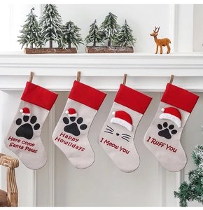 Set of 4 Christmas stockings with festive pet paw prints and holiday quotes on a mantel