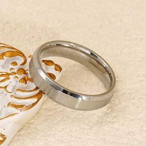 Macro shot of brushed stainless steel ring with polished beveled edges on stone