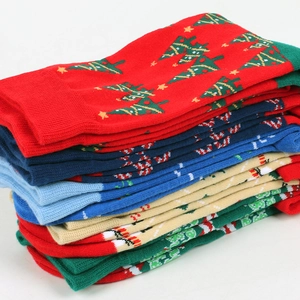 Stacked Christmas cotton socks featuring festive patterns of trees, candy canes and snowflakes