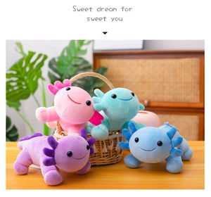 Cute axolotl plush toys in pink, blue, and purple displayed on a cozy wooden desk