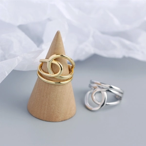 Close-up of double-layer S925 sterling silver wire-wrapped twist rings in gold and silver