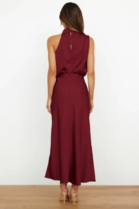 Detail of burgundy sleeveless halter satin dress showing the slim fit back and glossy drape