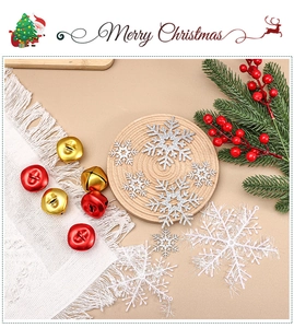 Detailed overhead shot of glittery snowflakes and red bells for Christmas decorations