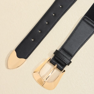 Detail of black leather belt featuring a golden metal buckle and polished tip finishing