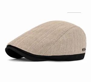 Macro detail of khaki striped flat cap with black brim and small metal logo plaque