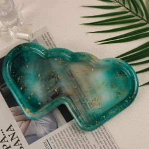 Detail of mushroom-shaped resin tray with green marble pattern and gold foil flakes