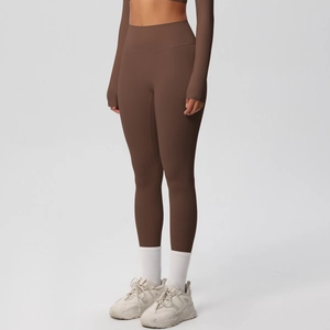 Close-up of high-waisted brown yoga pants featuring seamless design and matte finish fabric