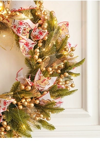 Close-up of 50cm Christmas wreath with LED lights, golden berries and festive ribbons