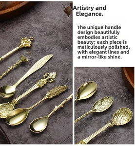 Detail of vintage gold dessert spoon set with ornate handles on dark stone background