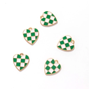 Detail of green and white checkerboard heart charms with gold edges on white background
