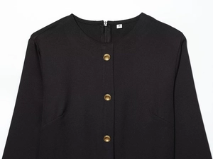 Détail de la robe midi noire avec boutons dorés et étiquette de taille S au col