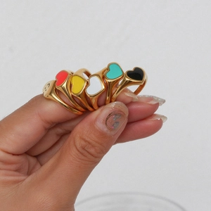 Five gold plated stainless steel heart enamel rings in red yellow white teal and black