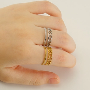 Stack of gold and silver stainless steel rings with Cuban link and rope designs