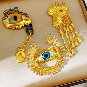 Detailed macro view of vintage eye-shaped brooches with blue enamel and rhinestones