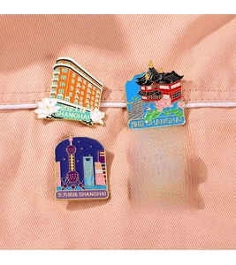 Set of four colorful enamel Shanghai landmark magnets on a soft pink fabric background