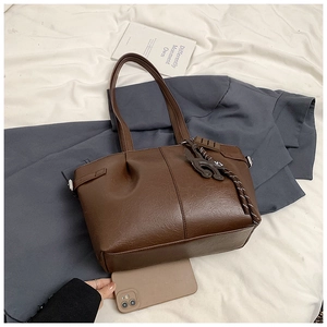 Deep brown pleated tote bag featuring leather texture and a cute rabbit shaped charm