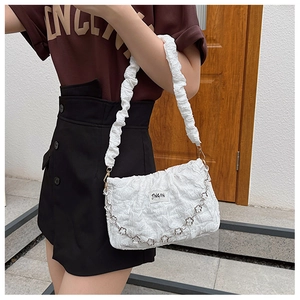 Detail of white pleated shoulder bag with floral metal chain and JINGPIN woven label
