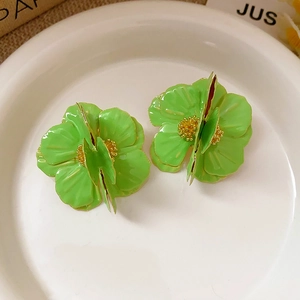 Macro shot of 3D green layered flower stud earring with glossy finish and gold center